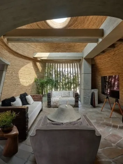 Inside my studio, the design continues the story of nature. The curved walls are finished with upcycled bamboo, the floor is raw stone, and an oculus in the ceiling bathes the space in natural light. This is a space designed to give मन को सुकून (peace of mind) and inspire creativity.