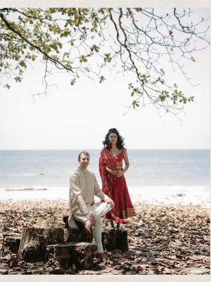 A portrait of a couple against the vastness of the ocean. This image from a beach wedding in Thailand captures the beauty of the natural surroundings and the couple's relaxed connection.
