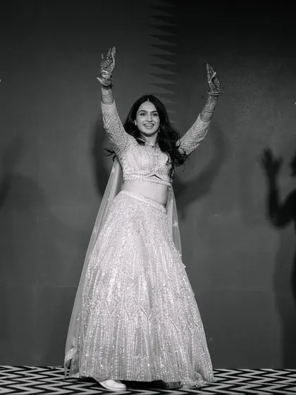 The bride who danced her heart out. This black and white shot captures the pure joy and energy of her solo Sangeet performance.
