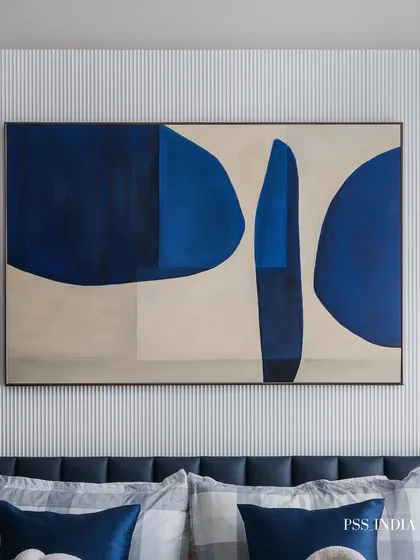 Art is essential for adding soul to a room. This large-scale abstract piece in shades of blue brings a powerful yet calming presence to this bedroom, set against a subtly fluted wall.