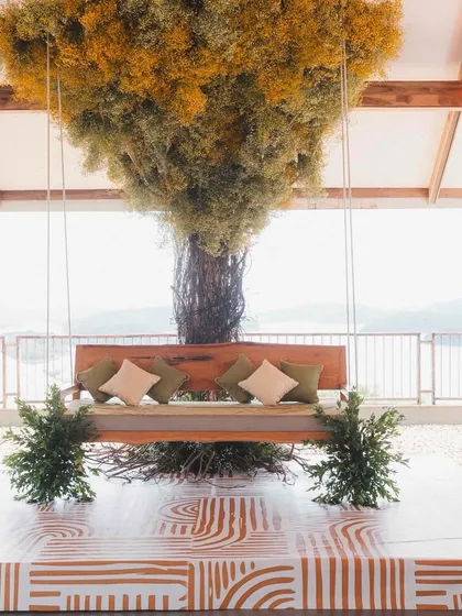 A closer look at the Bali-inspired Haldi decor. The custom swing, set against the backdrop of the lake, provided a stunning and unique seating area for the couple during their ceremony.