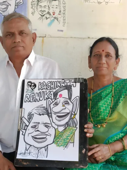 An older couple with their caricature from a family get-together in Lonavala. It's a timeless keepsake for them.