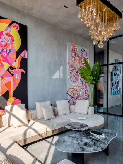 This living space is a testament to our maximalist philosophy, a space that is unapologetically vibrant and full of life. It features multiple artworks coexisting, including a large, colorful canvas painting and other sculptural elements, showing how we can orchestrate a symphony of art within a single room.