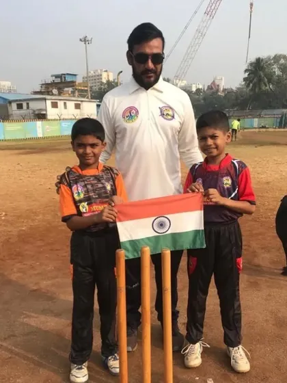 Me with two of my young students holding the Indian flag. We teach them to play with pride and passion.