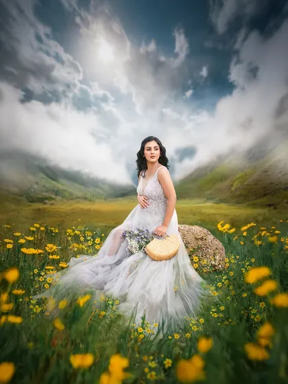 This is the essence of a fairytale maternity shoot. I create these magical, dreamlike scenes outdoors, using styling and editing to bring a vision to life in a field of flowers under a dramatic sky.