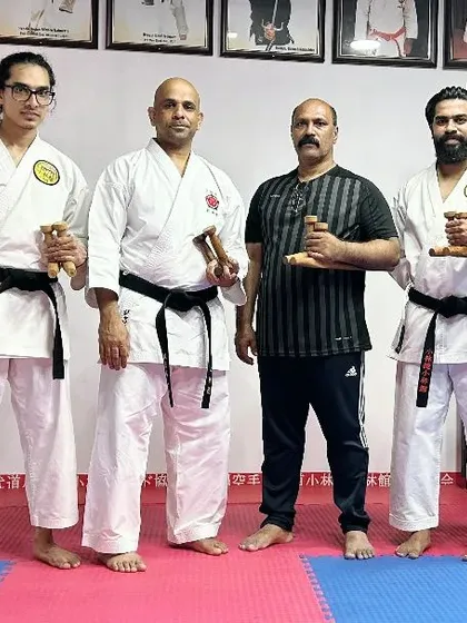 Another group photo with my instructors, holding the Tekko, another traditional Okinawan weapon.