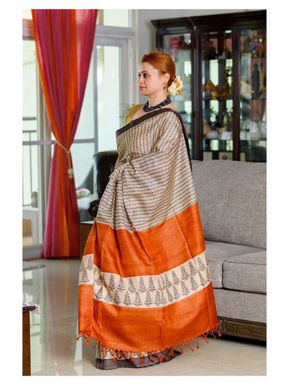 A side-profile shot that highlights the drape of the pallu and the texture of the handloom fabric.