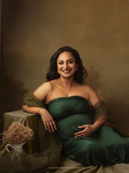 Relaxed and radiant, she leans against a table, the picture of serene confidence. This image was shared to celebrate the strength and beauty of women.