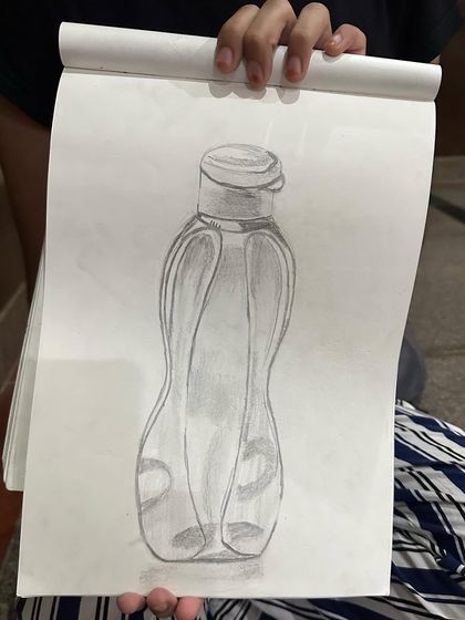 A student's sketch of a water bottle, a great exercise in drawing transparent and curved surfaces.