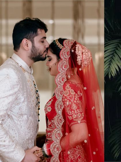 A groom's gentle kiss on his bride's forehead, a timeless expression of love and care captured on their wedding day.