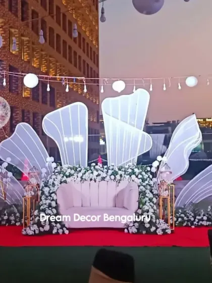 Here is a wider view of our modern anniversary stage setup against the city skyline. The combination of ambient string lights, glowing lanterns, and the illuminated backdrop created an unforgettable atmosphere for the evening celebration.