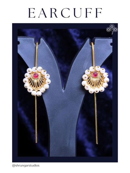 A simple and elegant earcuff design with pearls and a red stone.