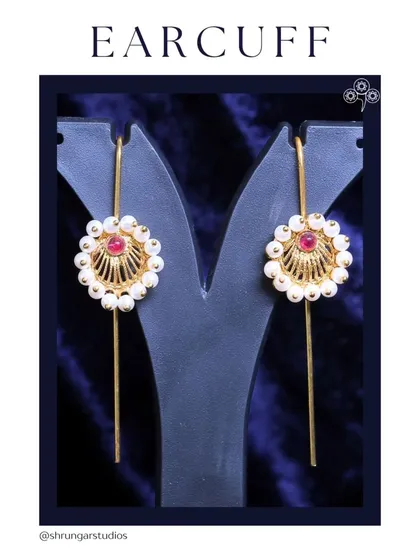 A simple and elegant earcuff design with pearls and a red stone.