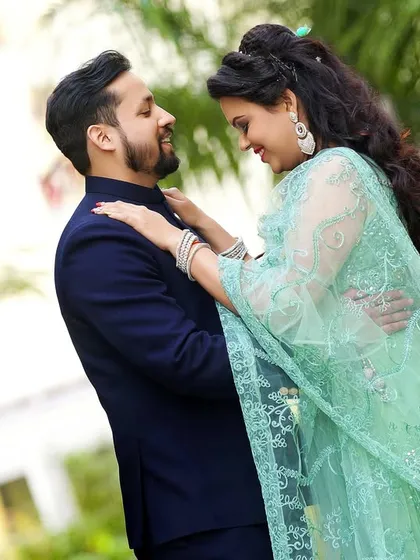 A playful and loving moment between the couple during their outdoor engagement shoot. The natural light and greenery create a fresh and happy vibe.