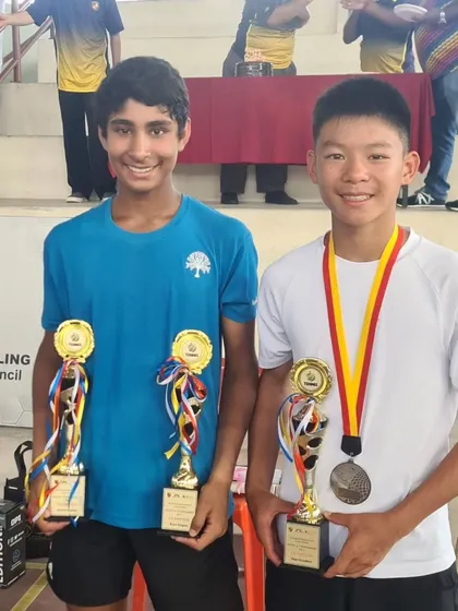 Tavish Pahwa with his partner Alex Hui after winning the doubles title at the Asian Grade A tournament in Malaysia. International partnerships broaden our players' experience.