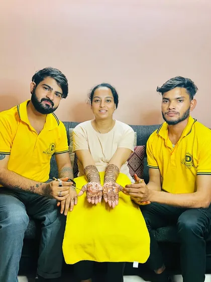 The happy mom-to-be with our artists after her baby shower mehndi session.