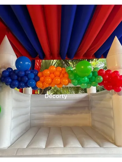 The superhero bouncy castle, ready for endless fun under a red and blue tented ceiling.