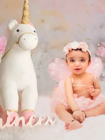 A happy little fairy with her unicorn. This portrait captures the magic and wonder of our fantasy-themed sessions.