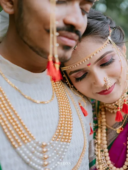 A detailed close-up shot focusing on the bride's serene expression and the magnificent traditional jewellery.