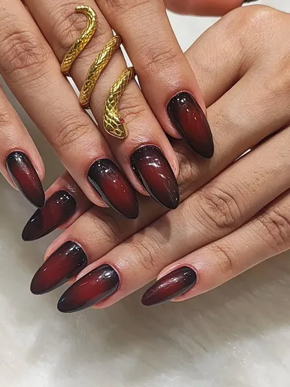 For a look that's both elegant and edgy, I created this stunning aura gradient effect. The design blends a deep burgundy into black on long almond-shaped extensions, creating a sophisticated and dramatic look that's perfect for making a statement.