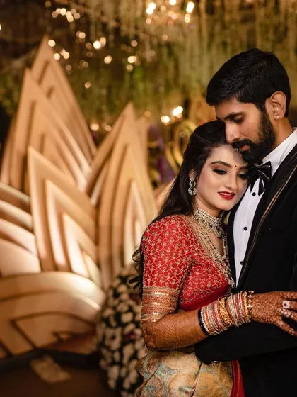 An intimate, warmly lit portrait of a couple sharing a quiet moment during their reception. We aim to capture the raw, unscripted emotions that make your wedding day unique.