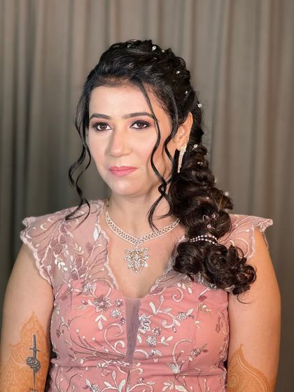 A beautiful and intricate side braid, studded with sparkling crystals for a glamorous cocktail or reception look.