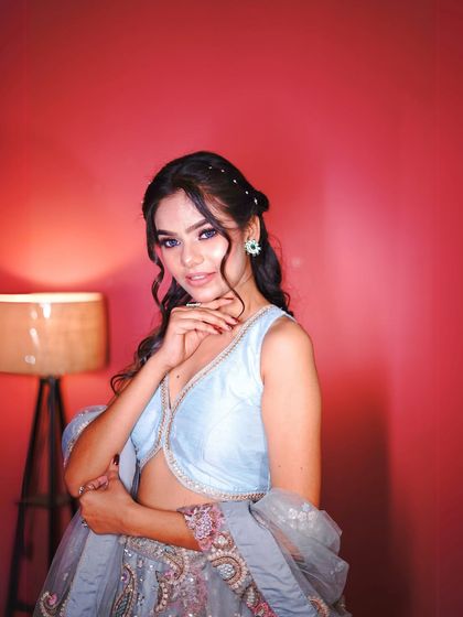 Here you can see the detailed floral threadwork in shades of pink and red on the grey-blue base. The craftsmanship makes this piece look truly high-end.