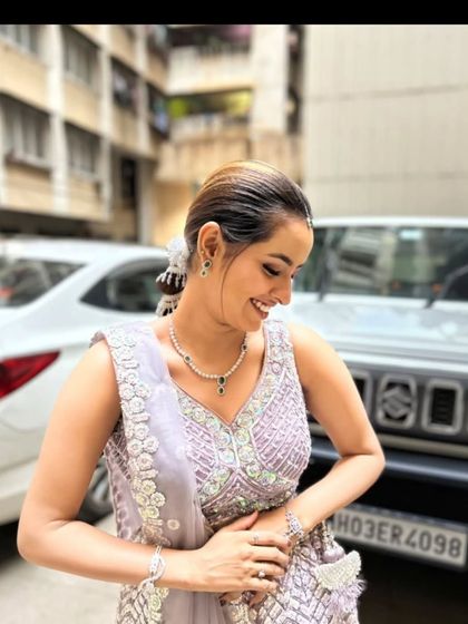 A candid, happy shot of a client in our lavender lehenga.