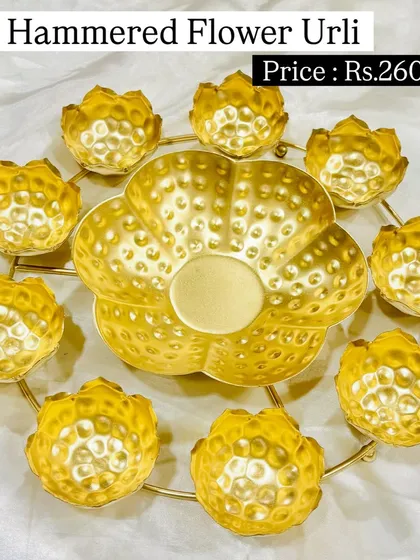 This hammered flower urli set is a beautiful centerpiece for floating candles or flowers. The golden, textured finish adds a touch of luxury to your festive or home decor.