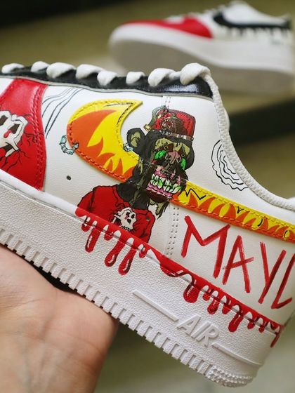 The full view of the MAYC NFT-themed sneaker. The design wraps around the shoe, with the "MAYC" lettering and dripping blood effect on the midsole for a bold, graphic look.