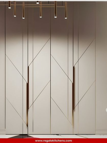 A statement wardrobe with geometric paneling and integrated handles. This design turns storage into a piece of art, adding a dynamic element to the room.
