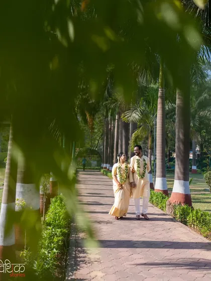 We love using natural elements to frame our subjects. Here, the lush green leaves of the palm trees create a natural vignette, drawing your eye to the couple as they take a peaceful walk together after their ceremony.