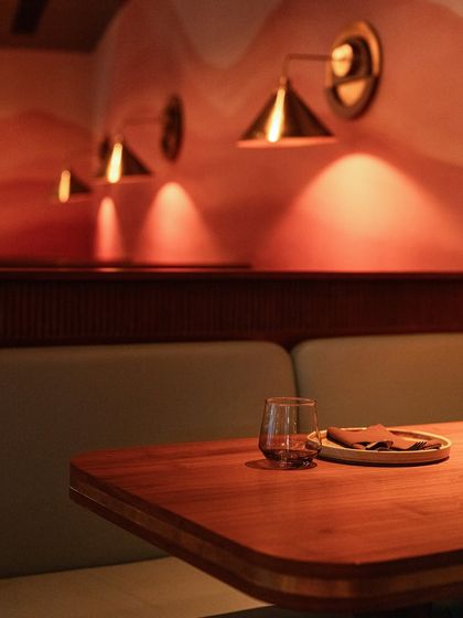 The soft glow from our wall sconces creates a cozy and intimate ambiance in our booth seating areas. It’s these thoughtful details that make our space feel special for any private gathering.