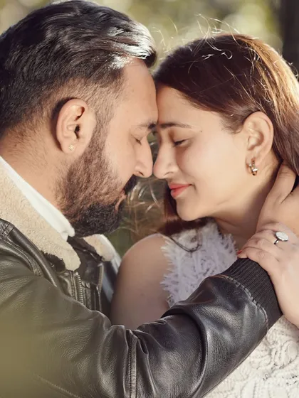 An intimate close-up of a couple, their foreheads touching, capturing a quiet moment of connection during their outdoor pre-wedding shoot.
