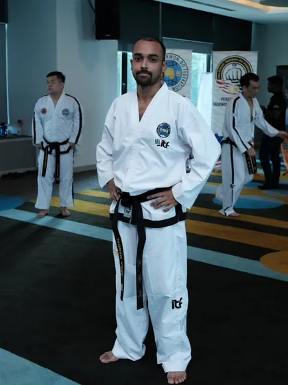 A moment of focus during a training seminar. I am surrounded by other dedicated black belts, all committed to deepening our knowledge of Taekwon-Do.