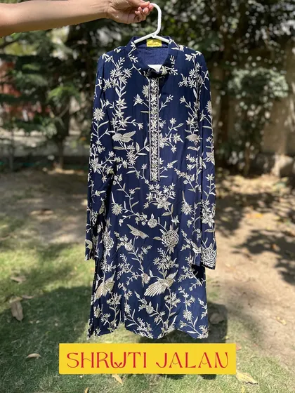 A closer look at the navy blue floral kurta for boys. The print is intricate, and the fabric is soft and comfortable.