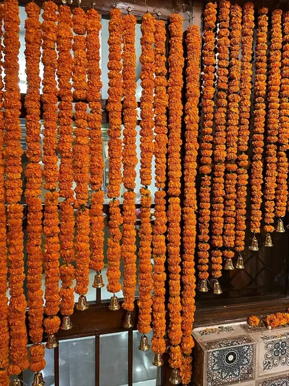 We love the classic combination of marigold garlands and temple bells. Here, we used them to create a traditional and auspicious window decoration.