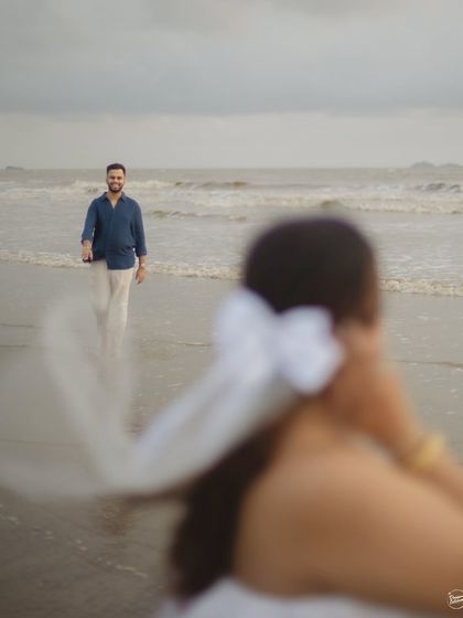 A creative shot focusing on the groom as he walks towards his partner on the beach. The selective focus adds an artistic and personal perspective to this Alibaug pre-wedding photo.