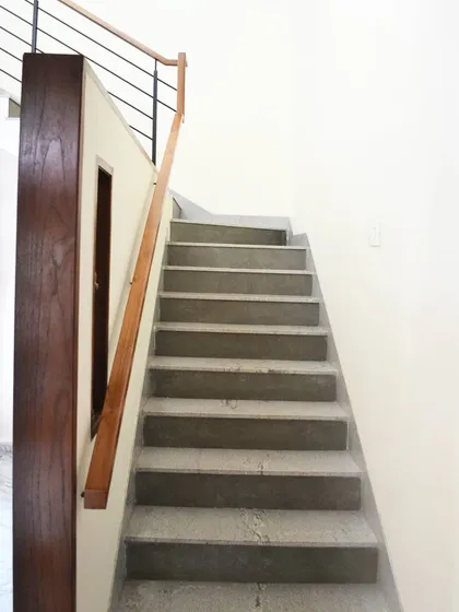 A simple, elegant polished concrete staircase. The design is minimalist, allowing the material and form to be the focus.