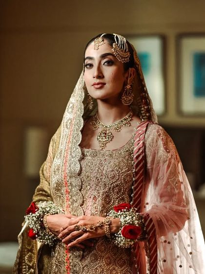 A stunning, classic portrait of a bride in her traditional Muslim wedding attire.