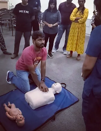 Another angle of a student practicing CPR, showing the focus and seriousness with which we approach this training.