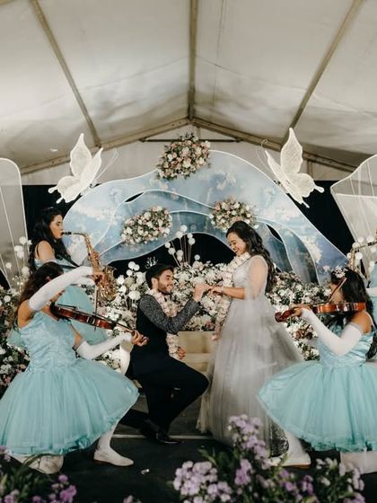 A grand and magical moment as the groom gets down on one knee to propose during the ring ceremony.