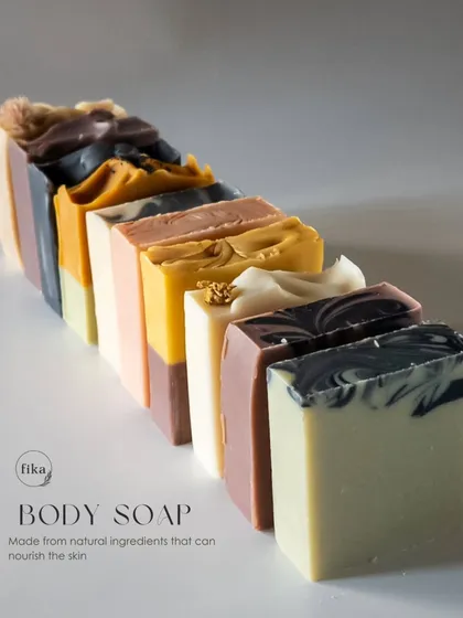 Behold the beautiful diversity of my body soap collection. Each bar is a unique piece of art, formulated with natural, plant-based ingredients to nourish the skin. This lineup shows the variety of colors and textures I can create, all derived from natural sources like mineral clays and botanicals.