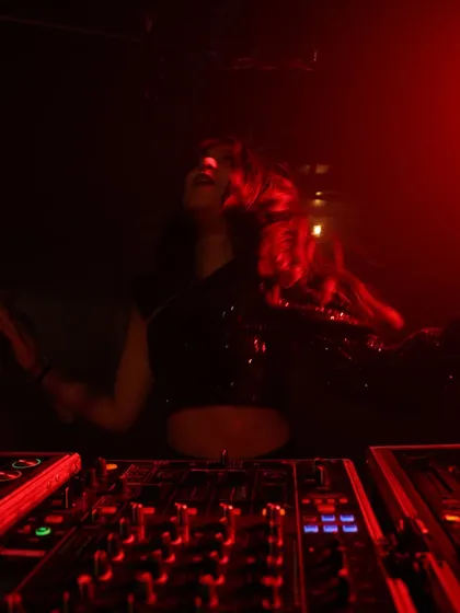 Hair flying, lost in the moment. This photo captures the physical energy I put into every set, dancing right along with the crowd.