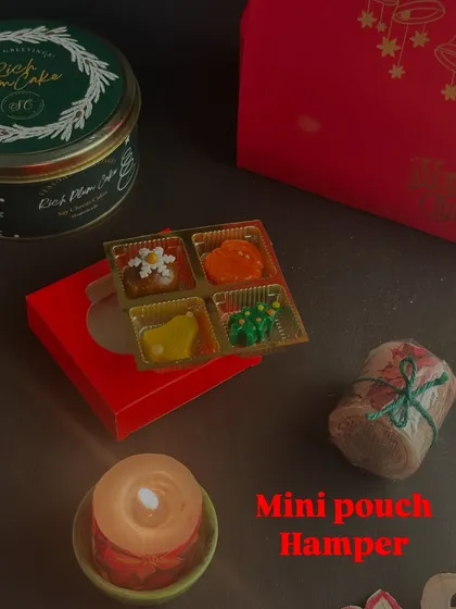 The Mini Pouch Hamper is a smaller, elegant gifting option for Christmas. It includes a selection of my bestsellers, like chocolates and a mini cake, presented in a festive pouch.