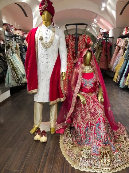 A glimpse of the magic in-store. This classic red bridal lehenga paired with an elegant white sherwani is a combination that never goes out of style, ready for you to rent.