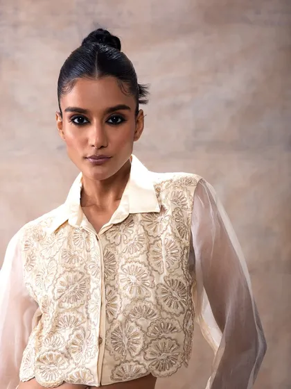 A fashion campaign look for Akashi Clothing. I created a sharp, winged eyeliner and a sleek updo to give a modern edge to this embroidered, organza shirt.