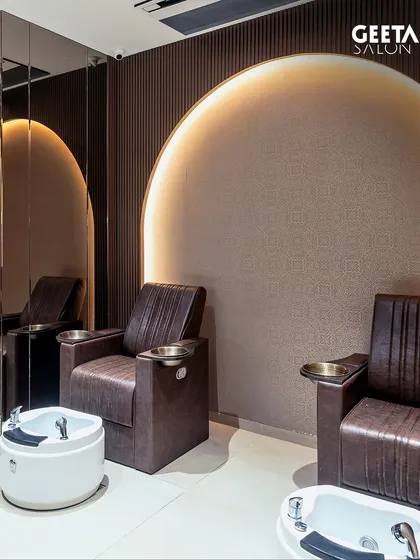 The pedicure section at our Ahmedabad salon, where style and serenity meet. The arched details and comfortable chairs are designed to help you relax and feel pampered.