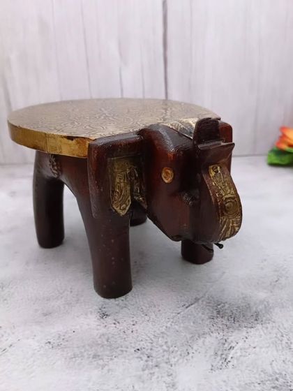 A side view of the wooden elephant bajoth, showing its sturdy construction and artistic form.