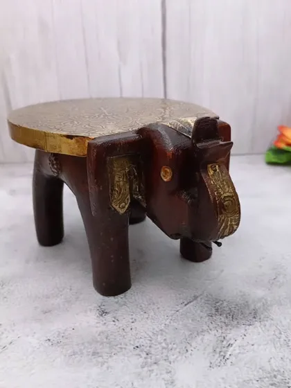 A wooden elephant-shaped bajoth (chowki) with a brass top, a beautiful and sturdy base to place your favorite idols.